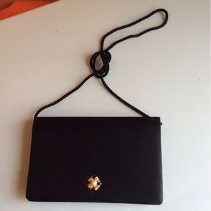 Simple small black purse with a gold flower and pearl